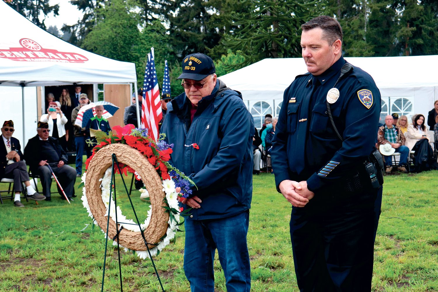 Pat Althauser, left, and Centralia Police Commander Andy Caldwell place a memorial wreath at Sticklin Greenwood Memorial Park during a rededication ceremony on Saturday.