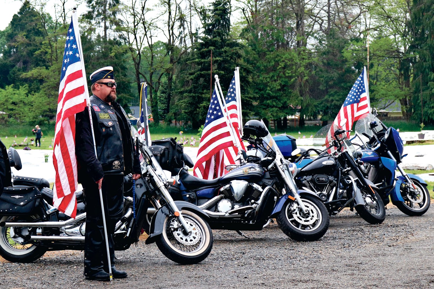 Kelly Rasmussen of the Post 25 American Legion Patriot Riders stands at attention during the Sticklin Greenwood Memorial Park Rededication Ceremony on Saturday.