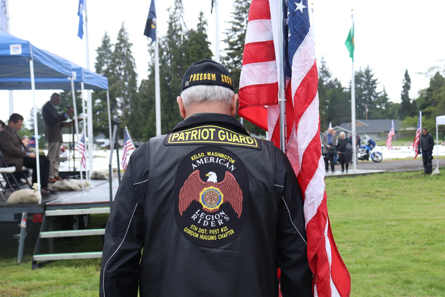 A member of Post 25 American Legion Patriot Riders stands at attention during the Sticklin Greenwood Memorial Park Rededication Ceremony on Saturday.