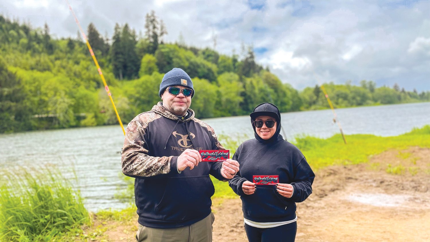 Rich and Julia Eaton pose for a photo at Friends Landing in Montesano next to their custom Meat Hunter poles.