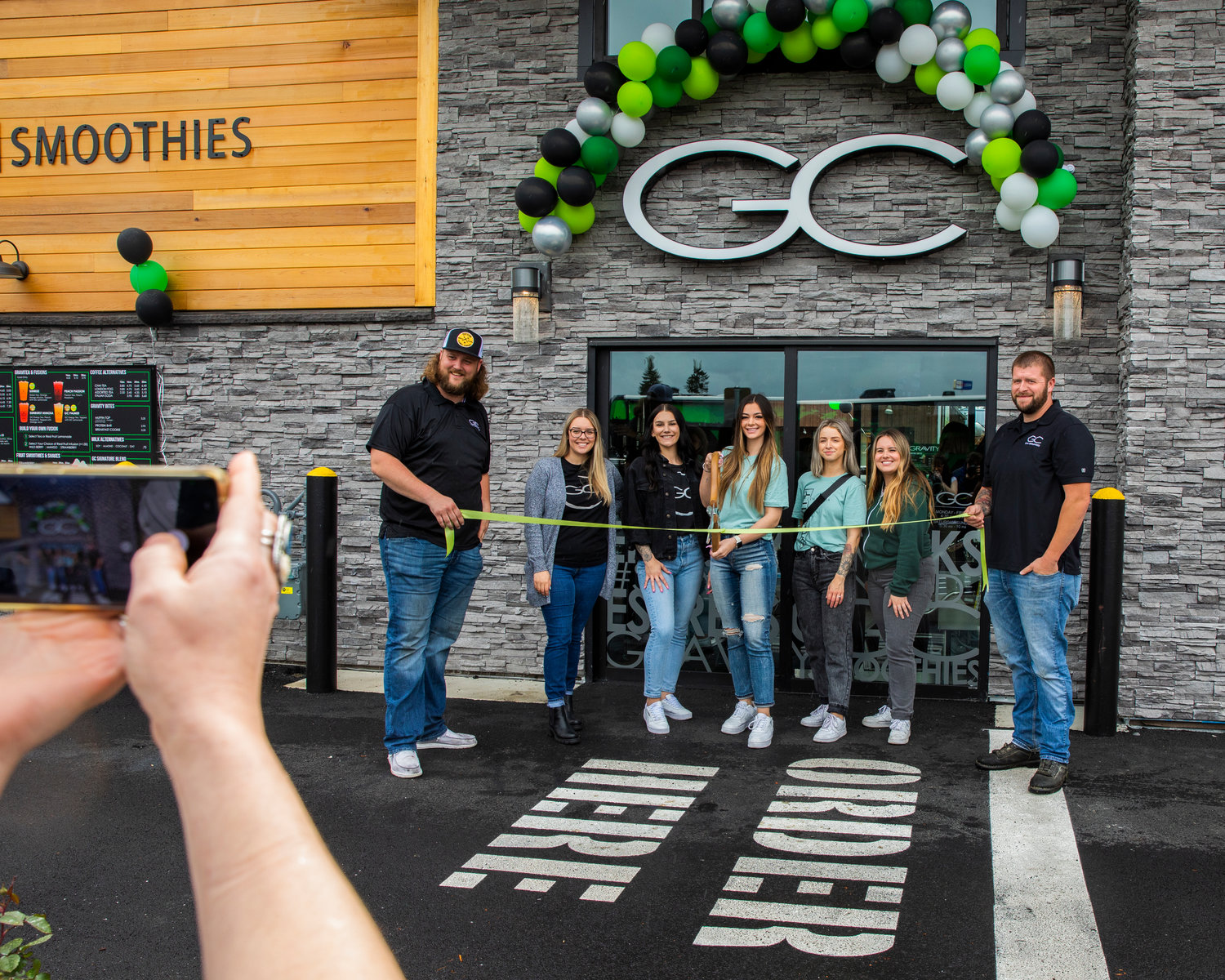 Employees at Gravity Coffee smile and pose for a photo during a grand opening and ribbon-cutting ceremony Friday in Centralia. The business is located at 712 Harrison Ave., Centralia.