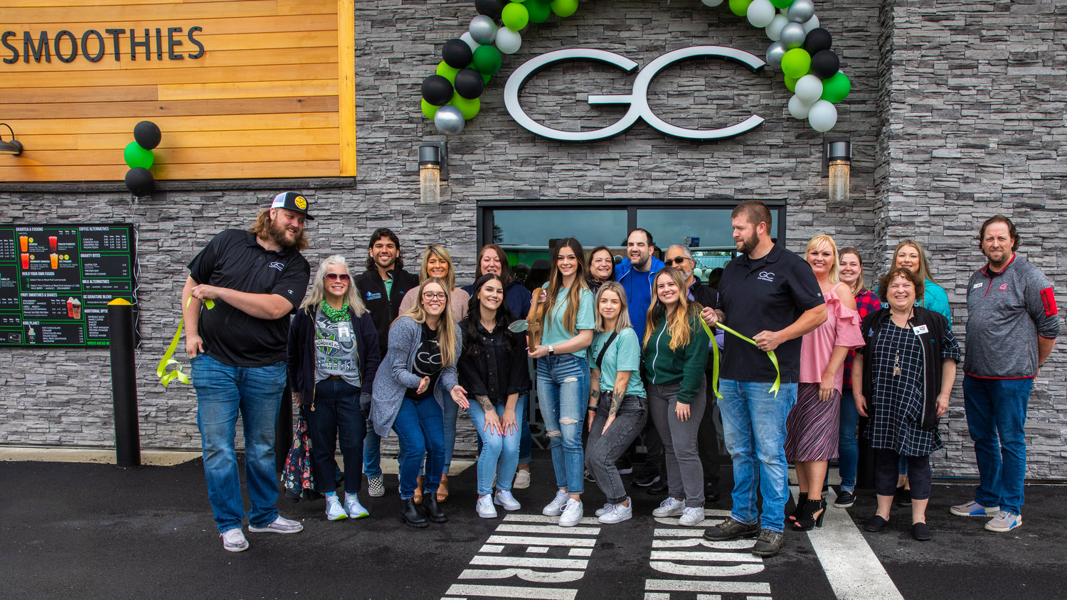 Attendees smile for a photo outside Gravity Coffee during a grand opening and ribbon-cutting ceremony Friday in Centralia. The event was hosted by the Centralia-Chehalis Chamber of Commerce. The business is located at 712 Harrison Ave., Centralia.