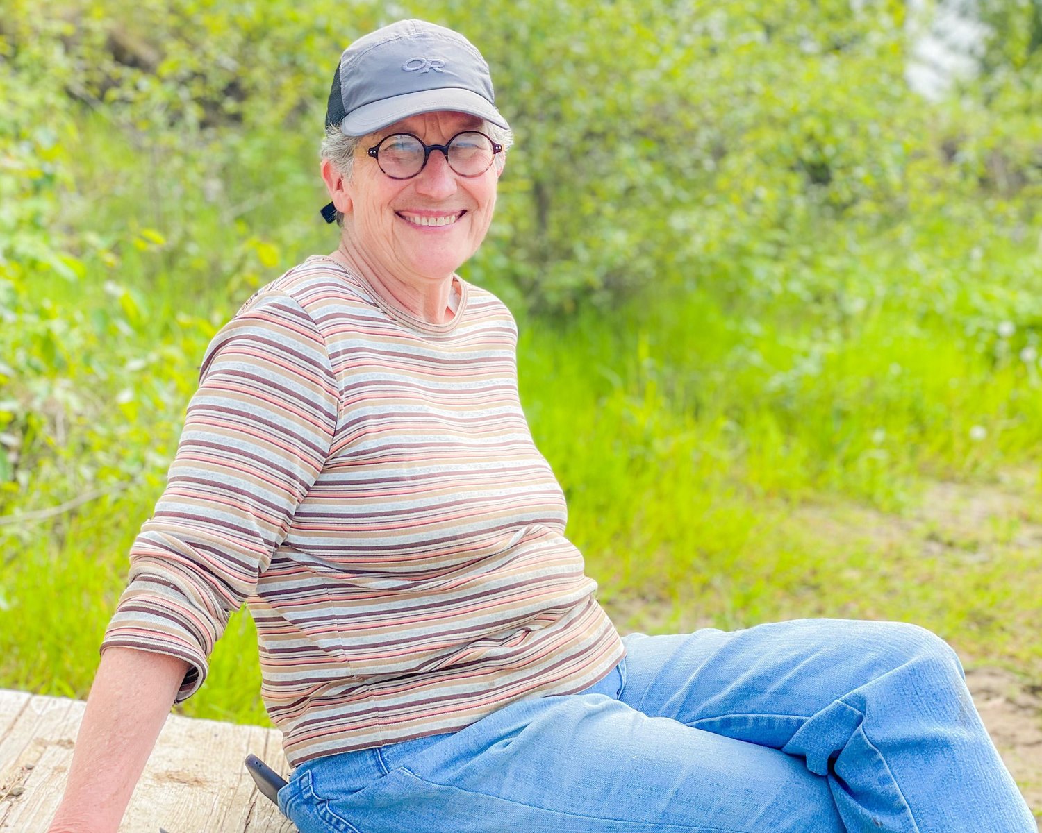 Betsie De Wreede, a retired farmer in the Independence Valley, smiles while sitting on a dock near her farm along the Chehalis River.