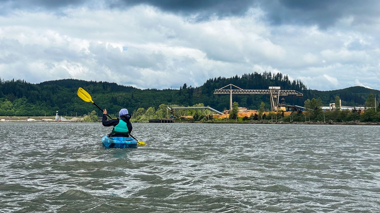 Reporter Isabel Vander Stoep paddles past Junction City along the Chehalis River on Monday.