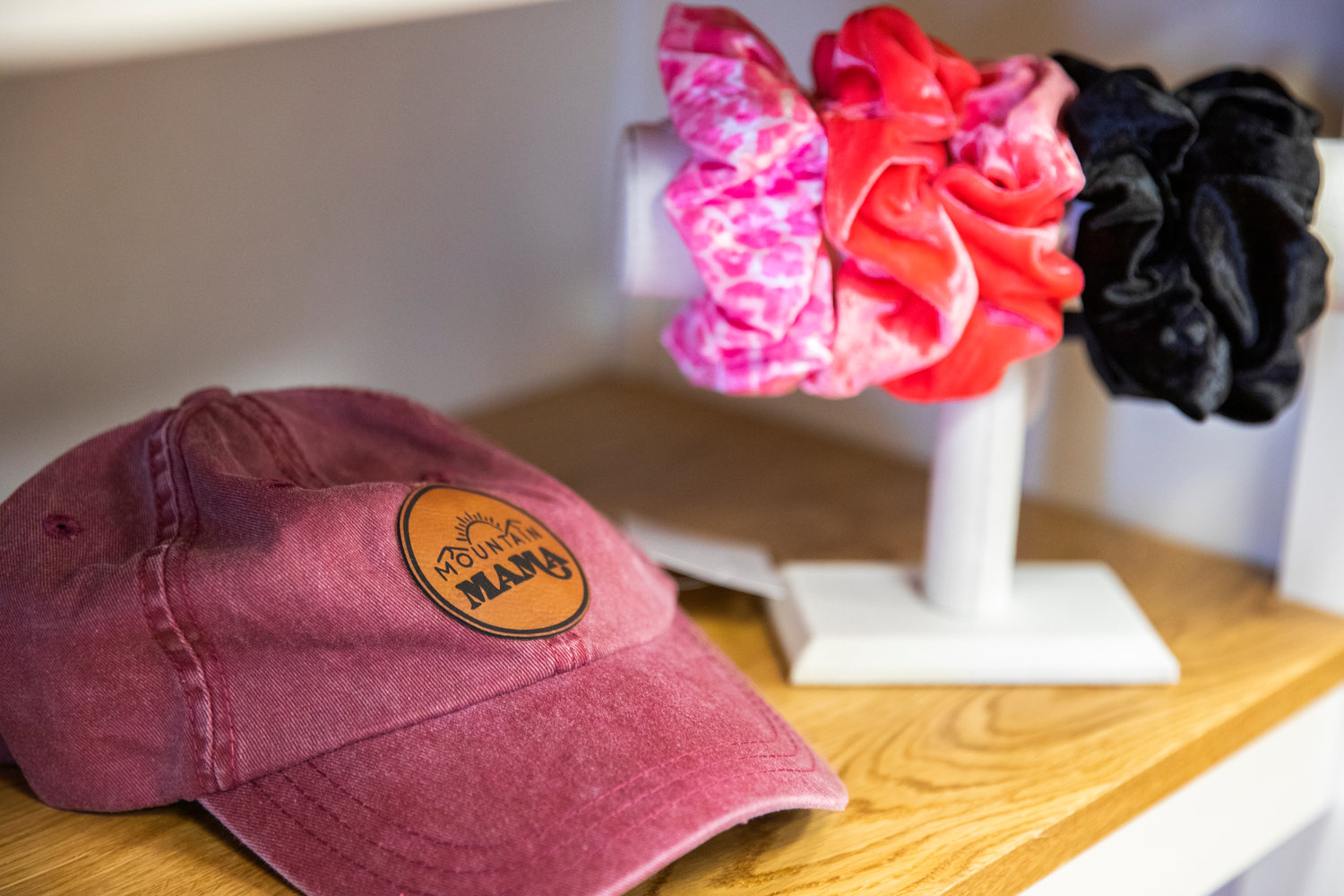 A hat displays a “Mountain Mama,” patch inside the “Milk + Honey,” boutique in Winlock.