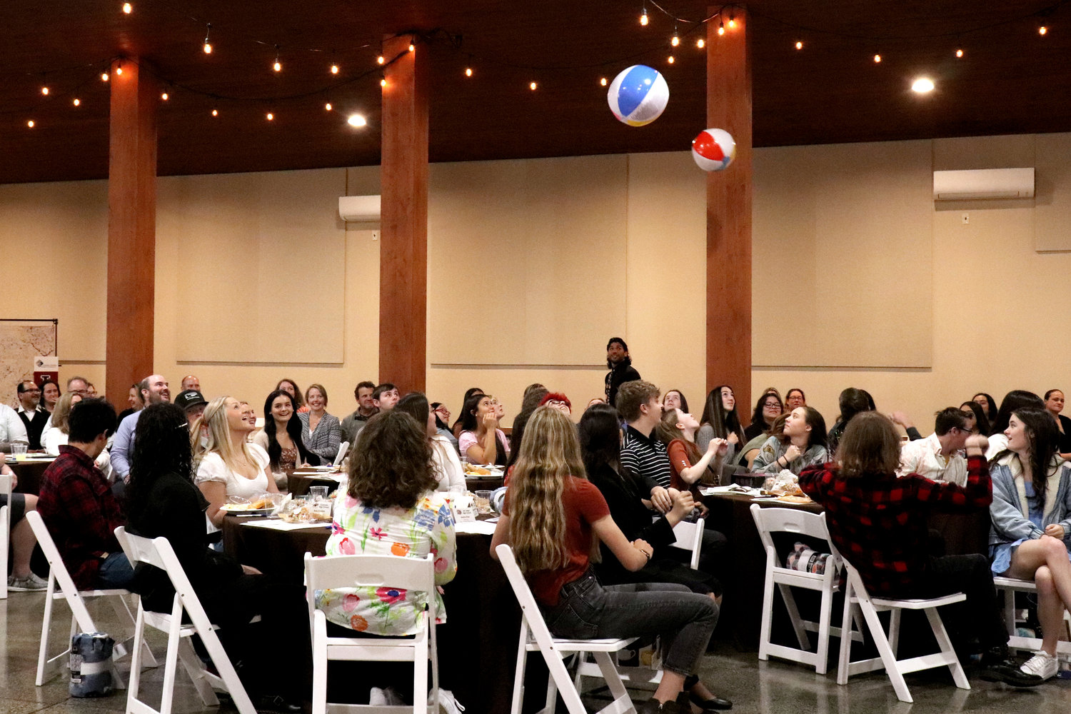 Beach balls descend towards graduating seniors and their families during the Rob Fuller Top 25 Scholarship Luncheon in Chehalis on Monday.