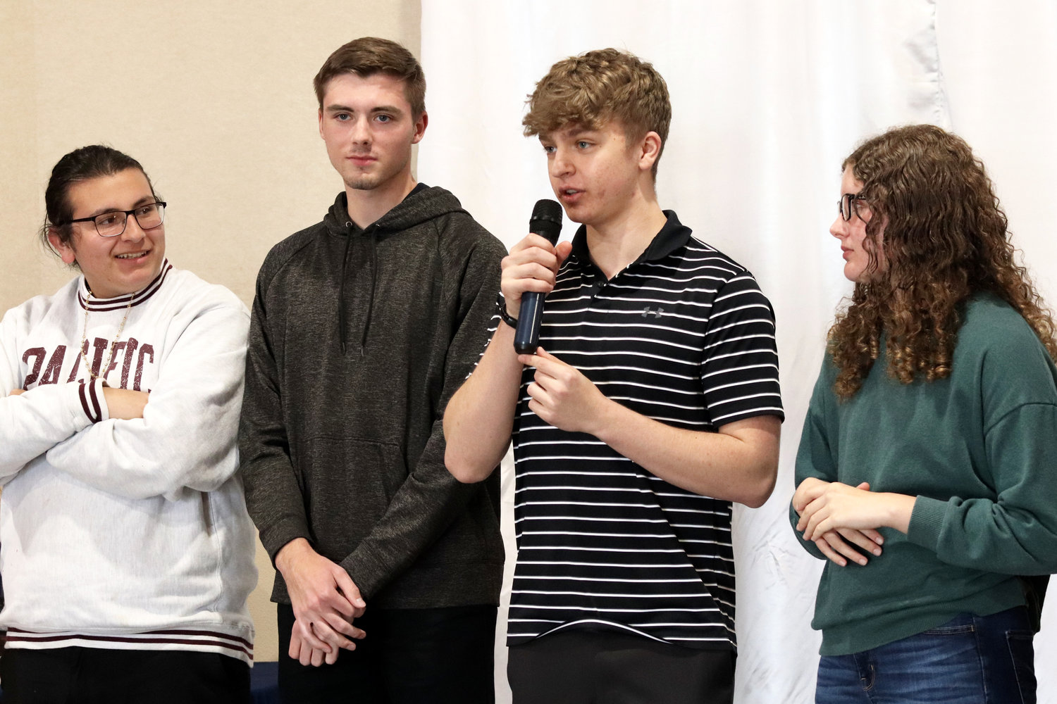 Austin Ulrigg of Centralia High School speaks during a scholarship luncheon in Chehalis on Monday about his plans to study math at the University of Washington. Next to Ulrigg, from left, are fellow Centralia seniors Victoriano Reyes, Landon Kaut and Lucy Nowicki.