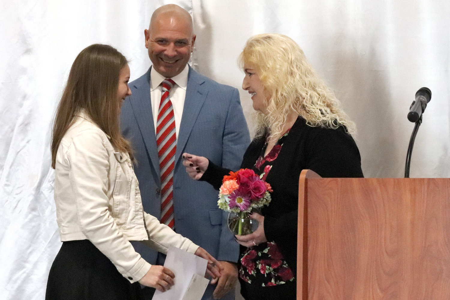 Debra Collinsworth and Rep. Peter Abbarno present the Cheyllyn Collinsworth Scholarship to Centralia senior Evie Rooklidge during the Rob Fuller Top 25 Scholarship Luncheon in Chehalis on Monday.