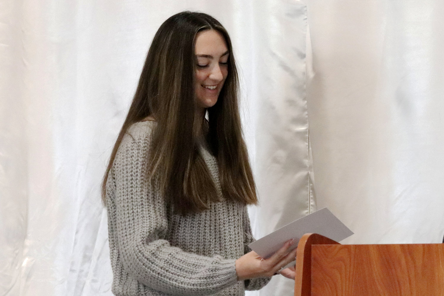 W.F. West senior Claire Kuykendall smiles as she receives a scholarship from Title Guaranty Company of Lewis County during the Rob Fuller Top 25 Scholarship Luncheon in Chehalis on Monday.