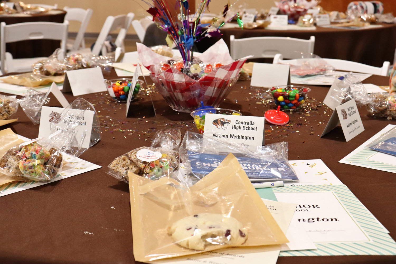 Treats donated by various businesses in Lewis County lie scattered across a table at the Rob Fuller Top 25 Scholarship Luncheon in Chehalis in Monday.