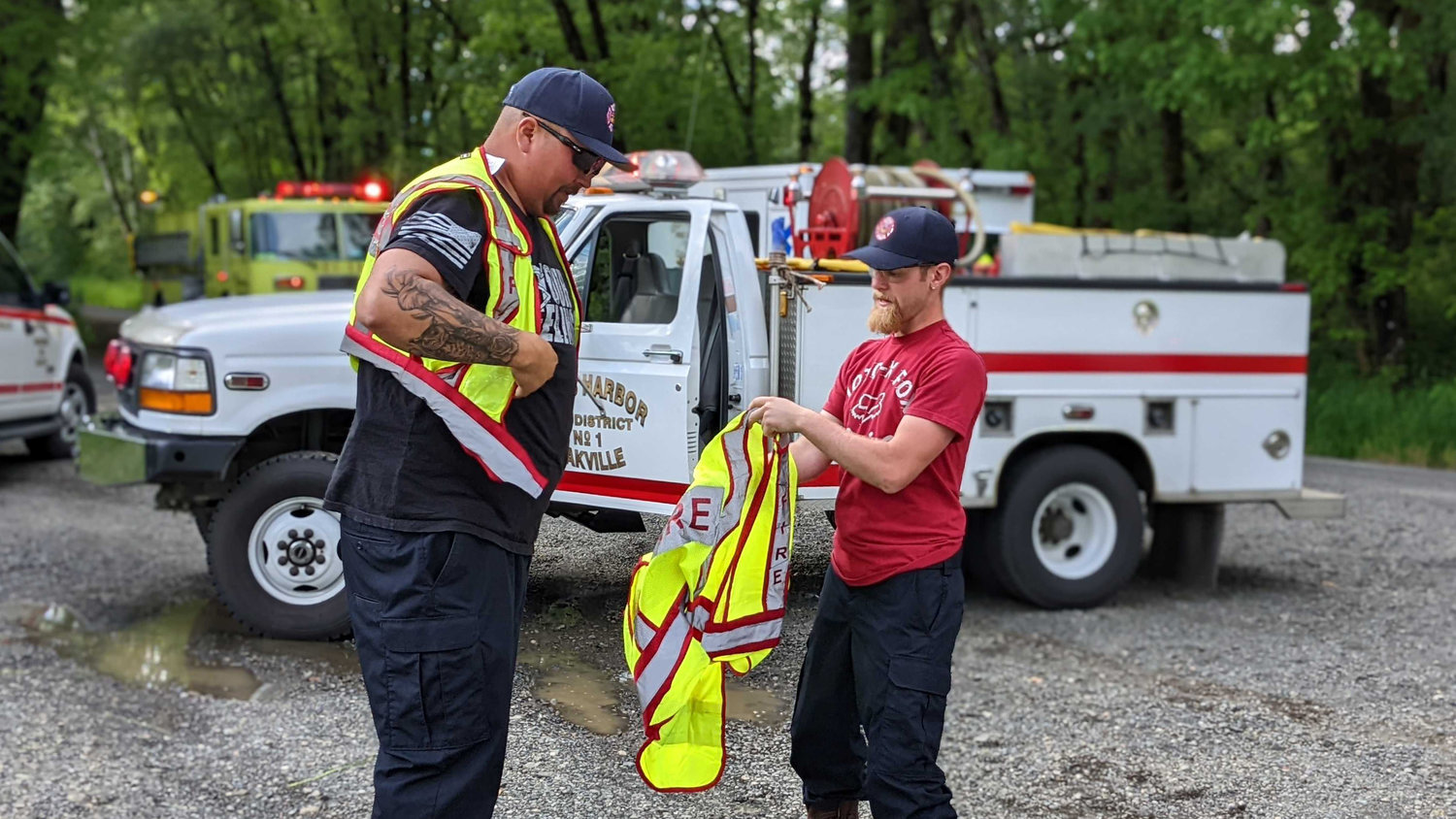 Jeremy Anderson and Cory Antony from Grays Harbor Fire District 1 don their vests after being on the team that saved a man from the Chehalis River when his canoe tipped on Saturday.