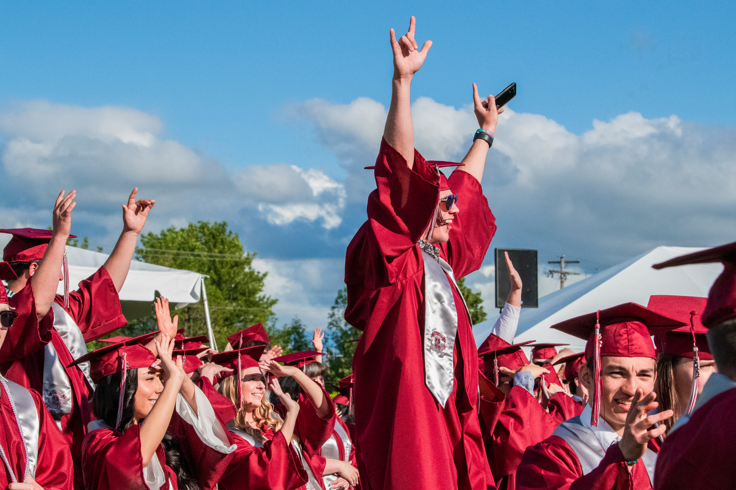 W.F. West graduates smile and wave to parents at Bearcat Stadium during a ceremony Saturday in Chehalis.