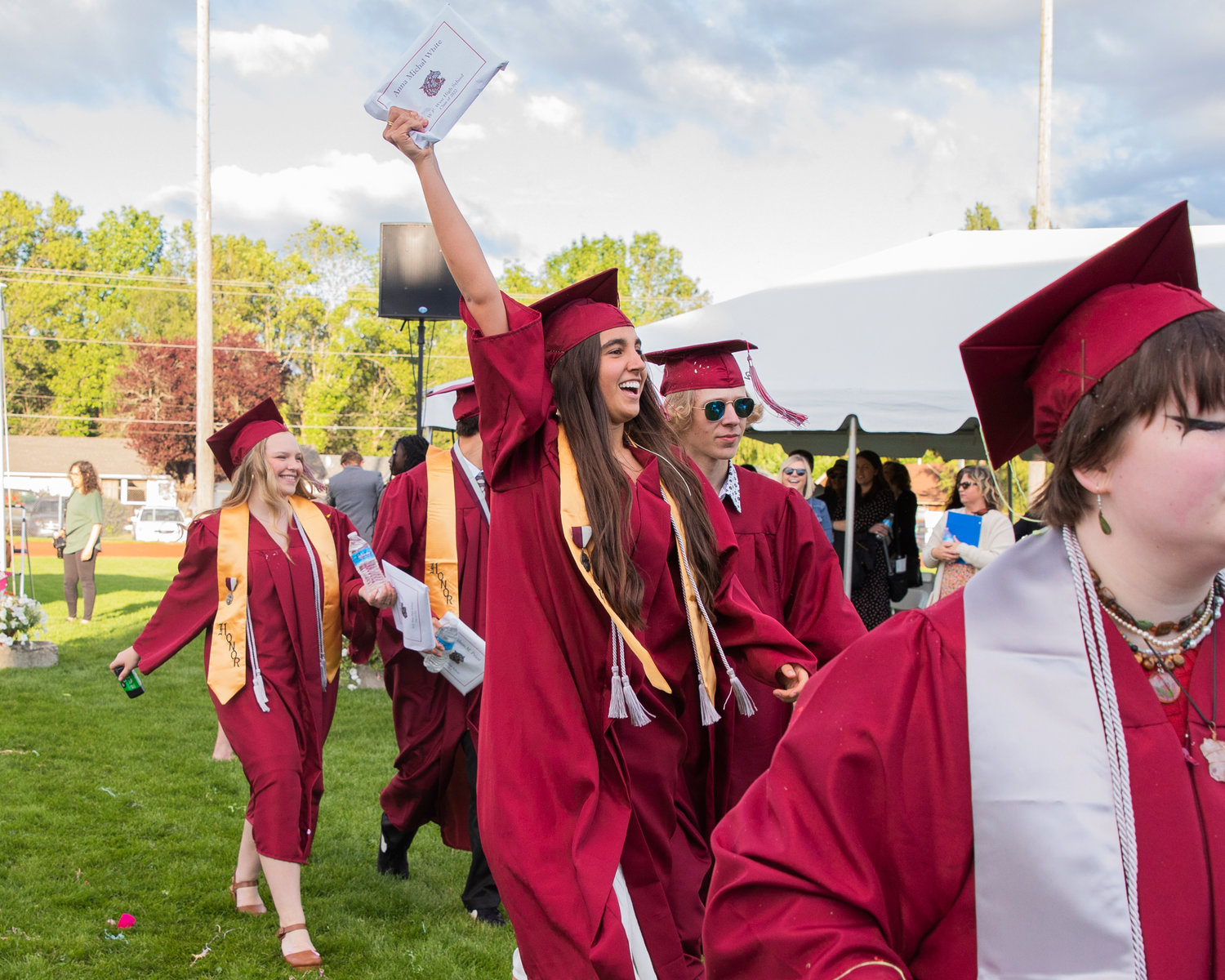 Anna White holds up her diploma following a graduation ceremony Saturday at Bearcat Stadium in Chehalis.
