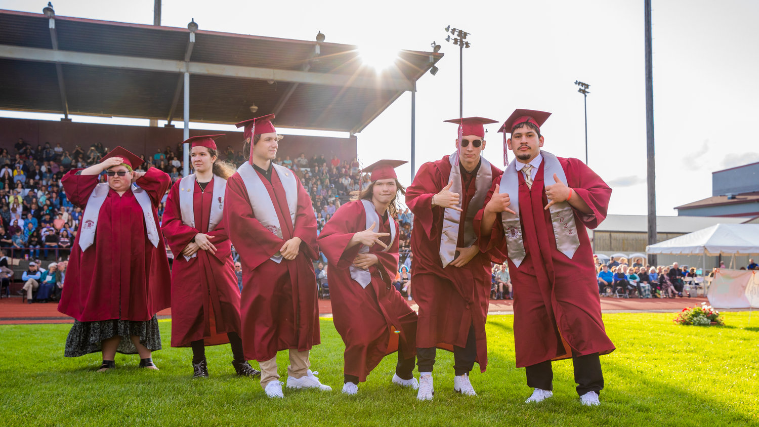 Graduates pose for a photo as they prepare to receive their diplomas Saturday outside W.F. West High School in Chehalis.