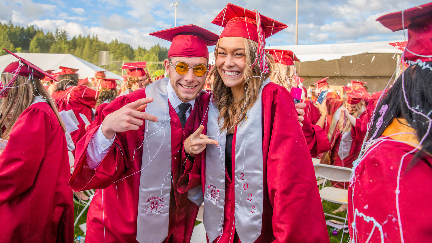 W.F. West graduates smile and pose while covered in Silly String at Bearcat Stadium Saturday in Chehalis.