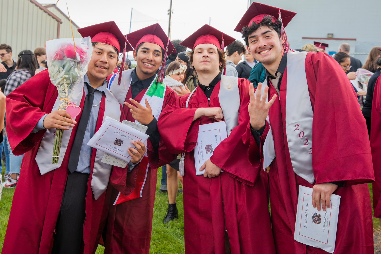 Graduates pose for a photo with their diplomas at Bearcat Stadium Saturday in Chehalis.