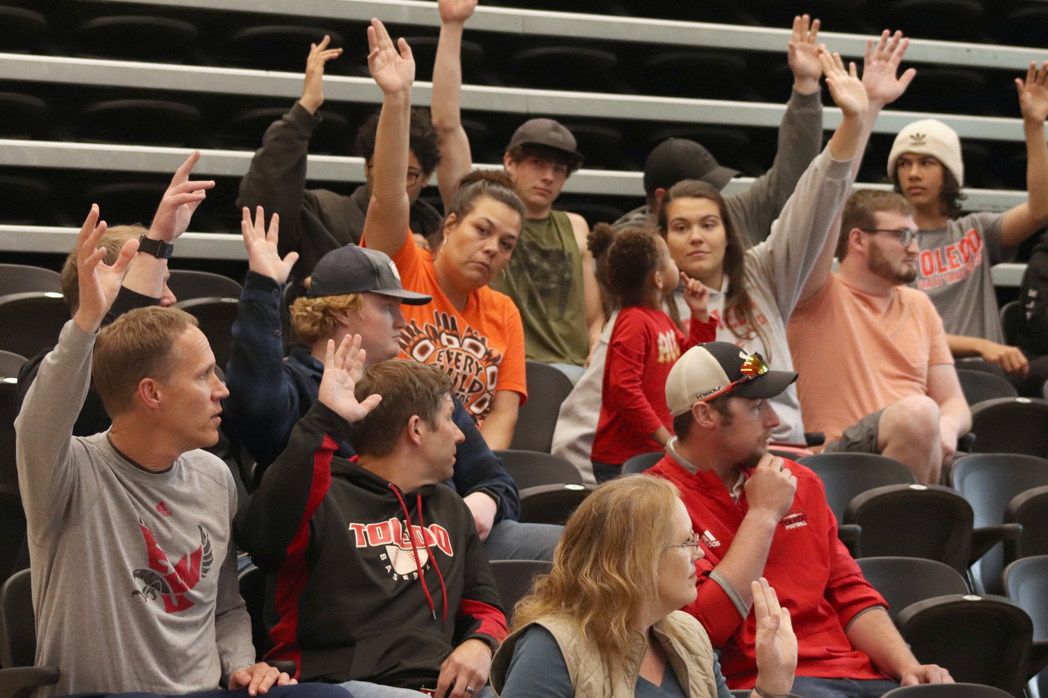 Toledo citizens raise their hands in support of a theoretical ballot measure to fund a new track and stadium during a community at Toledo High School on Tuesday.