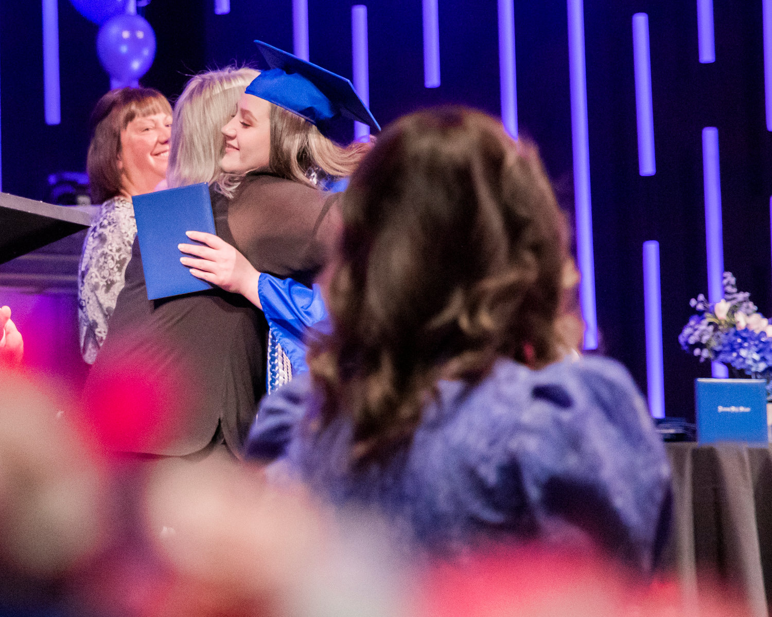 Haley Orr receives a hug and her diploma during a graduation ceremony for Futurus High School on Tuesday.