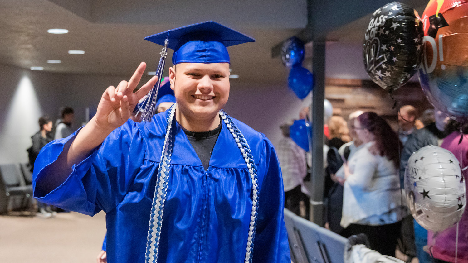 Daniel Lopez smiles and gestures before receiving his diploma from Futurus High School in Centralia on Tuesday.