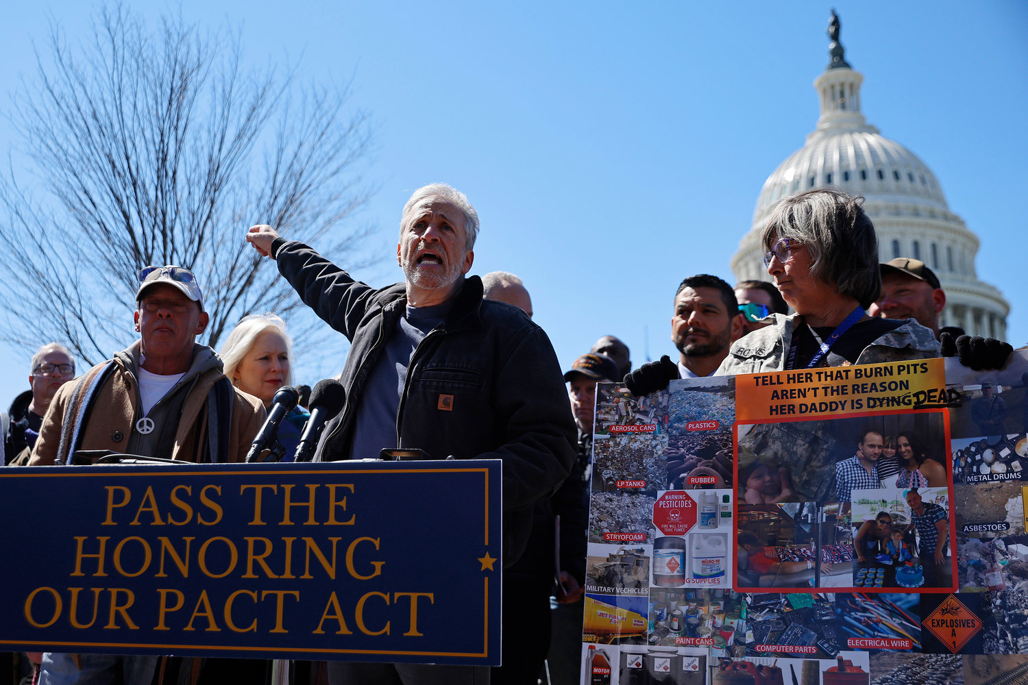 Comedian and activist Jon Stewart, middle, speaks during a news conference about military burn pits legislation with veterans advocacy groups and Democratic members of Congress outside the U.S. Capitol on Tuesday, March 29, 2022, in Washington, D.C. (Chip Somodevilla/Getty Images/TNS)