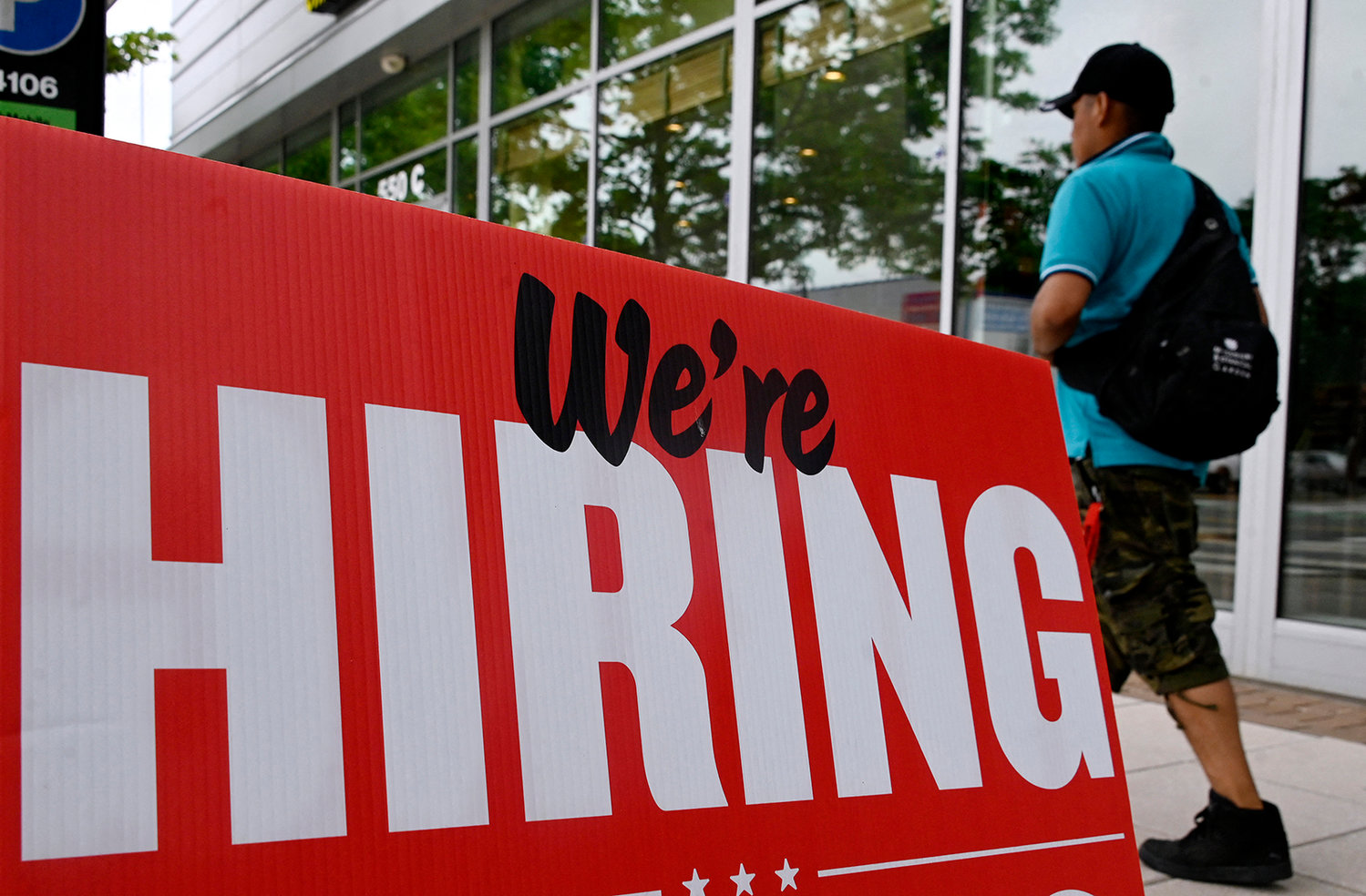 A man walks past a "now hiring" sign posted outside of a restaurant in Arlington, Virginia on June 3, 2022. (Olivier Douliery/AFP via Getty Images/TNS)