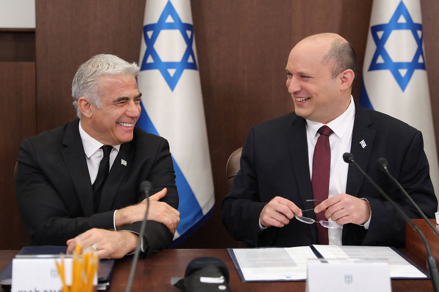 Israeli Prime Minister Naftali Bennett (right) speaks with Foreign Minister Yair Lapid (left) during a cabinet meeting at the Prime minister's office in Jerusalem, on June 19, 2022. (Abir Sultan/Pool/AFP via Getty Images/TNS)