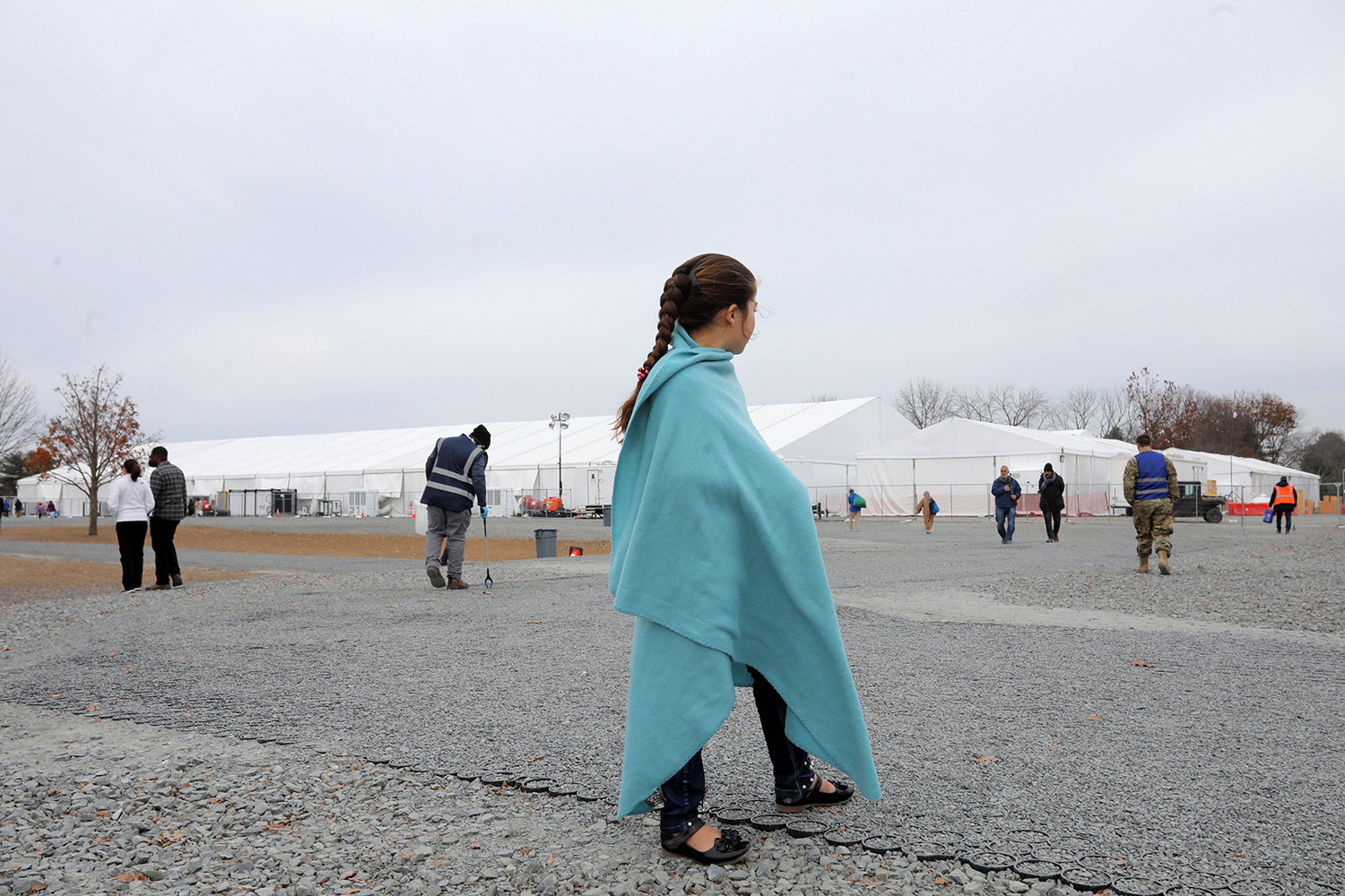An Afghan girl looks on at temporary housing in Liberty Village  on Dec. 2, 2021, in Joint Base McGuire-Dix-Lakehurst, New Jersey. (Barbara Davidson/Pool/Getty Images/TNS)
