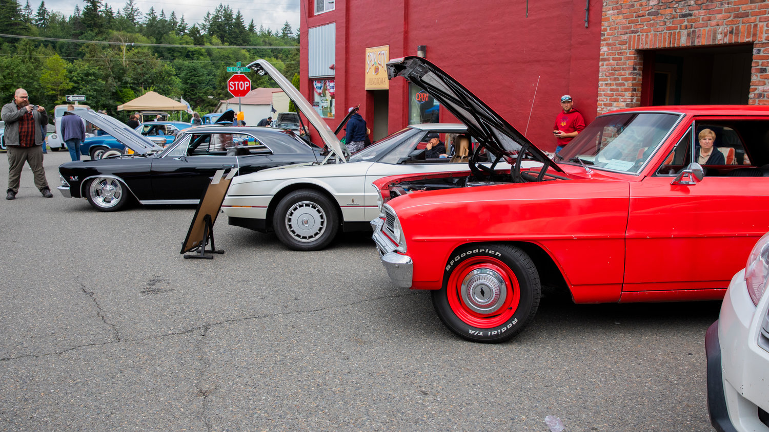 Cars with open hoods display engines at the Winlock Custom Car Show Saturday morning.