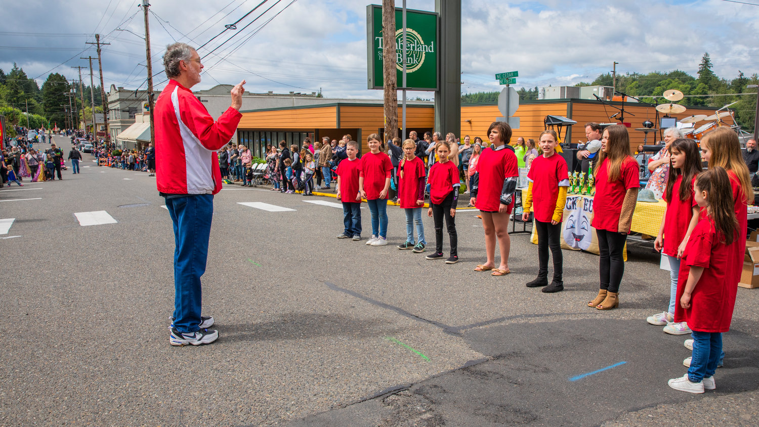 Kids sing and crowds cover their hearts before the start of the Egg Days Festival parade in Winlock on Saturday.