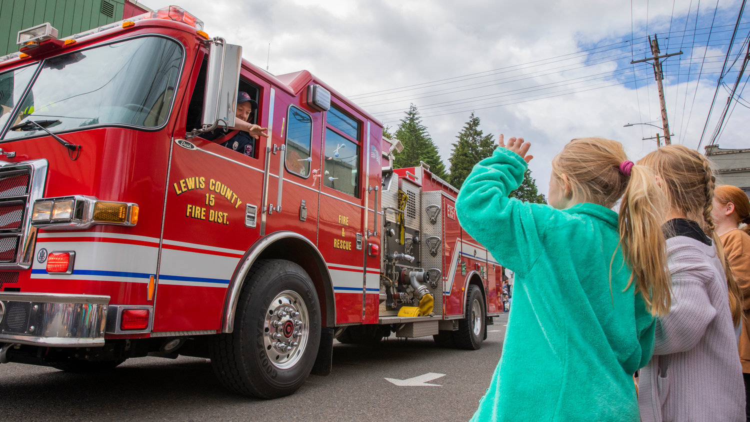 Members of Lewis County Fire District 15 throw candy during the Egg Days Festival parade in Winlock on Saturday.