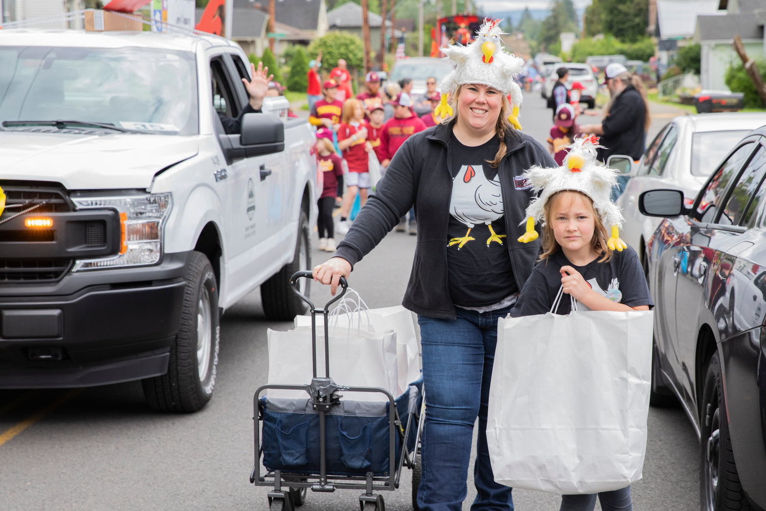 Erika Katt smiles while pulling a wagon with bags full of plastic eggs and candy during the Egg Days Festival parade in Winlock on Saturday.
