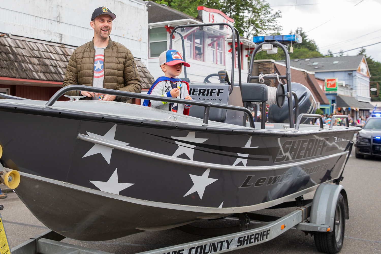 Commissioner Sean Swope laughs while throwing candy from a Lewis County Sheriff boat during the Egg Days Festival parade in Winlock on Saturday.
