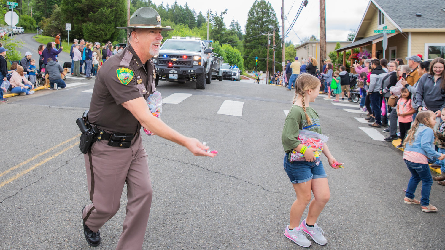 Sheriff Rob Snaza smiles while tossing candy during the Egg Days Festival parade in Winlock on Saturday.