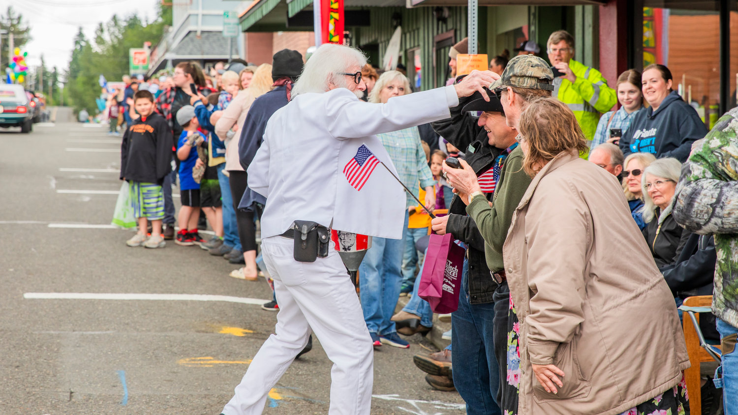 Jim Taylor dressed as Colonel Sanders greets visitors in downtown Winlock during the Egg Days Festival parade on Saturday.