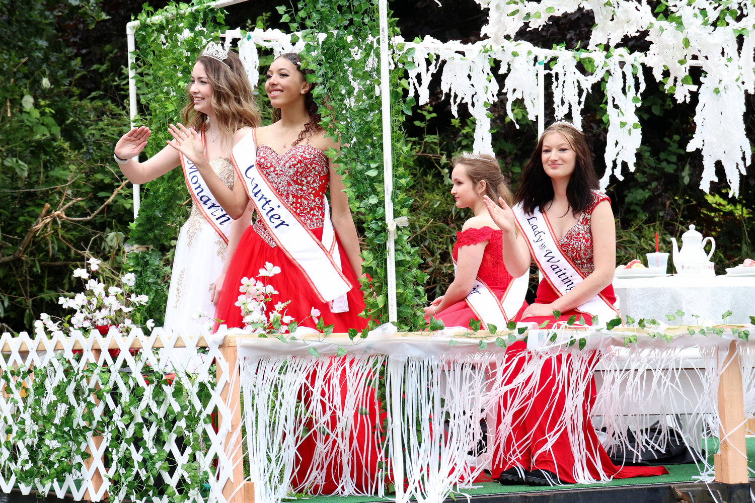 Members of the Oakville Independence Day Royalty Court wave from a float in the Swede Day Parade in Rochester on Saturday.