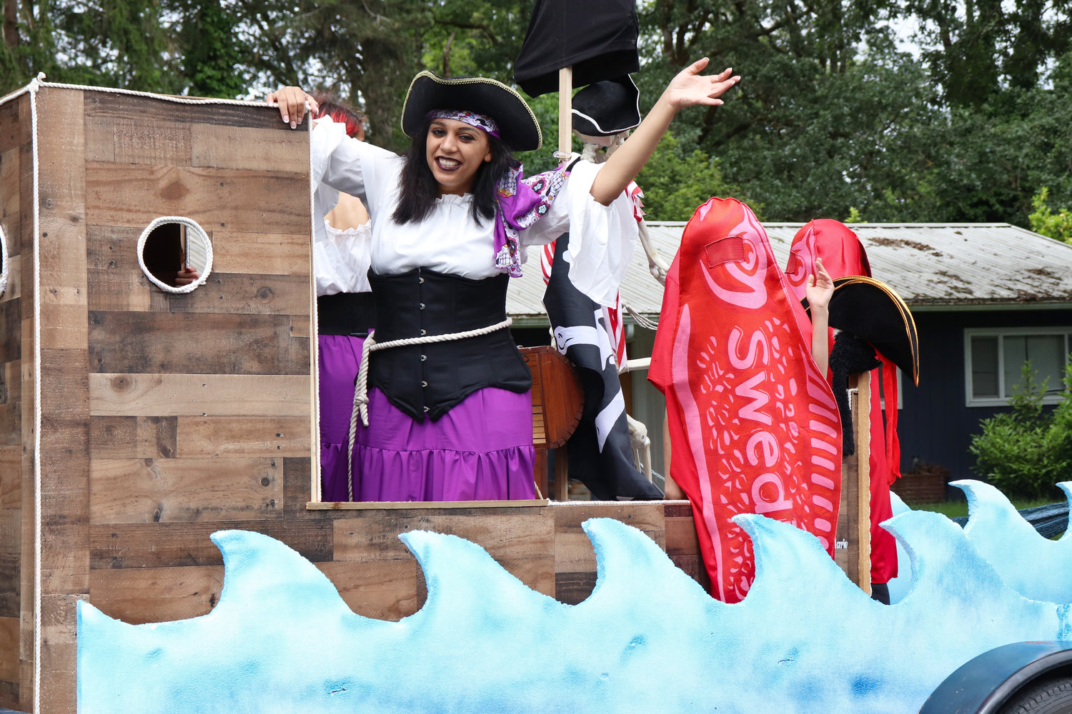 A pirate and a Swedish Fish wave from a float in the Swede Day Parade in Rochester on Saturday.