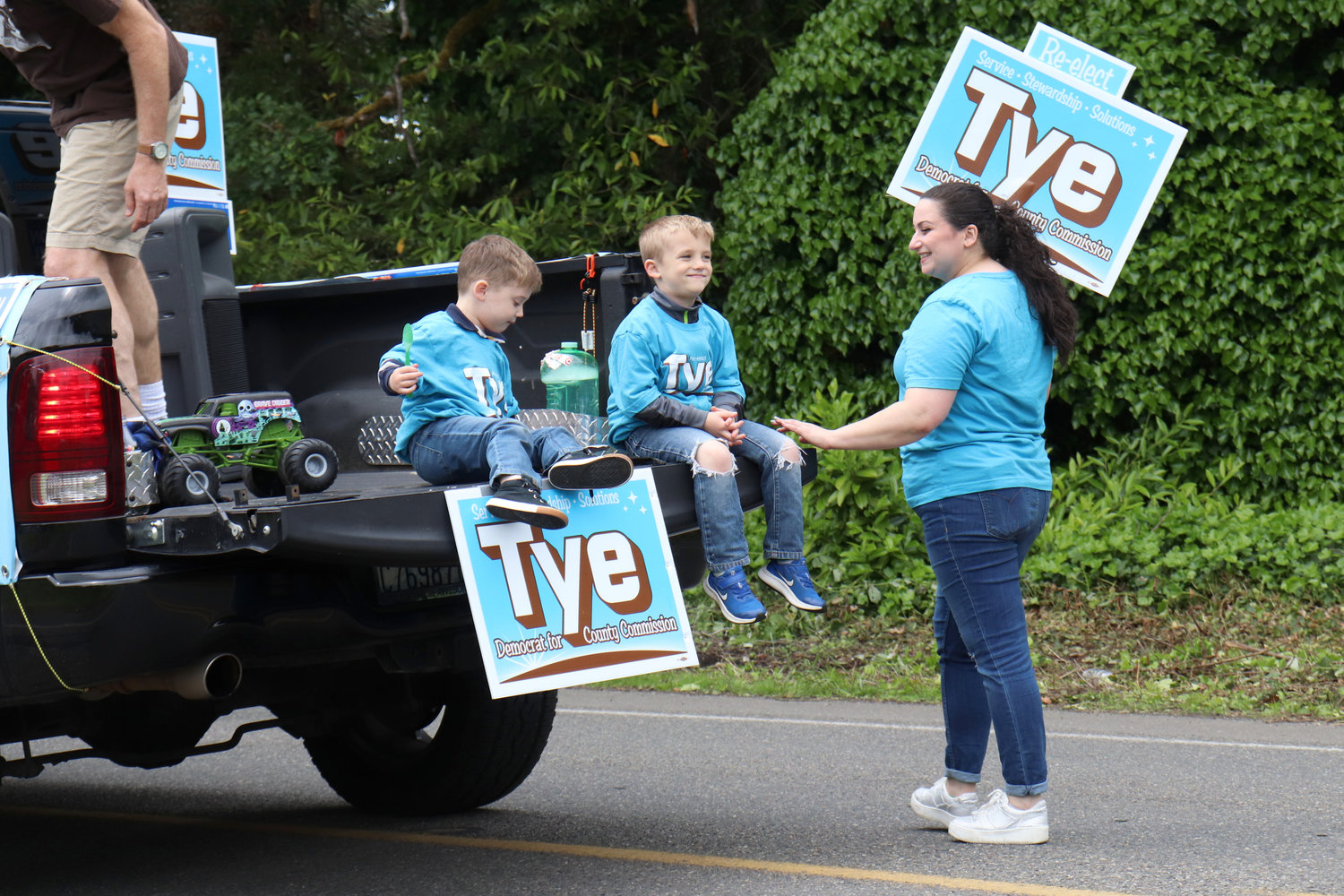 Children ride the back of a float promoting Thurston County Commissioner Tye Menser’s re-election campaign during the Swede Day Parade in Rochester on Saturday.