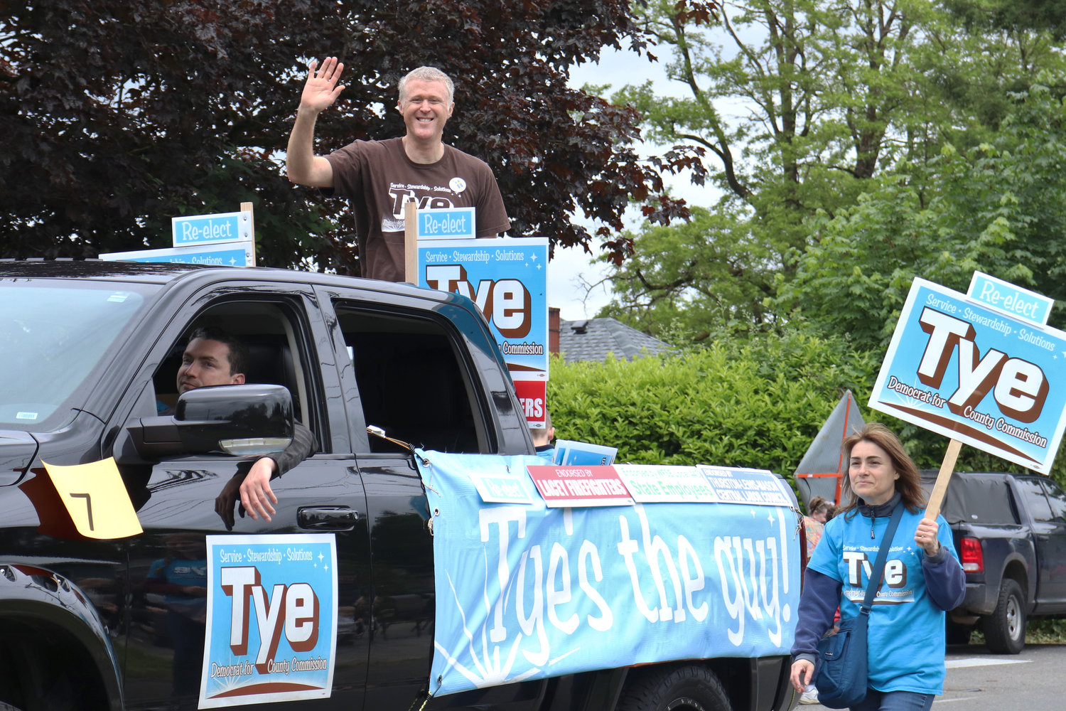 Thurston County District 3 Commissioner Tye Menser waves from the back of a pickup during the Swede Day Parade in Rochester on Saturday.