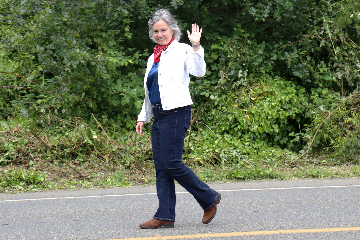 Rep. Sandy Kaiser, D-Olympia, of the 35th District, waves during the Swede Day Parade in Rochester on Saturday.