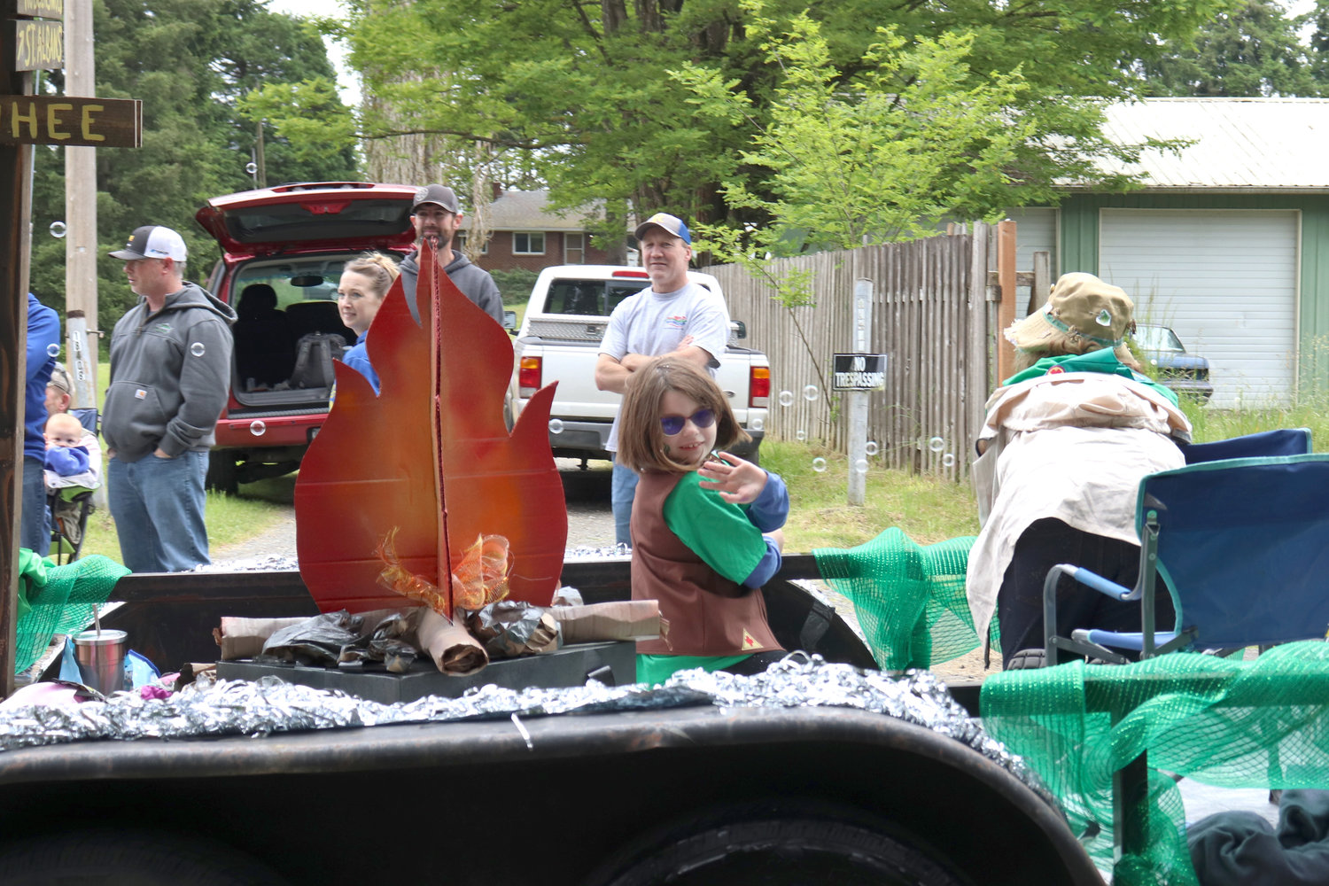 A Girl Scout waves from a float during the Swede Day Parade in Rochester on Saturday.