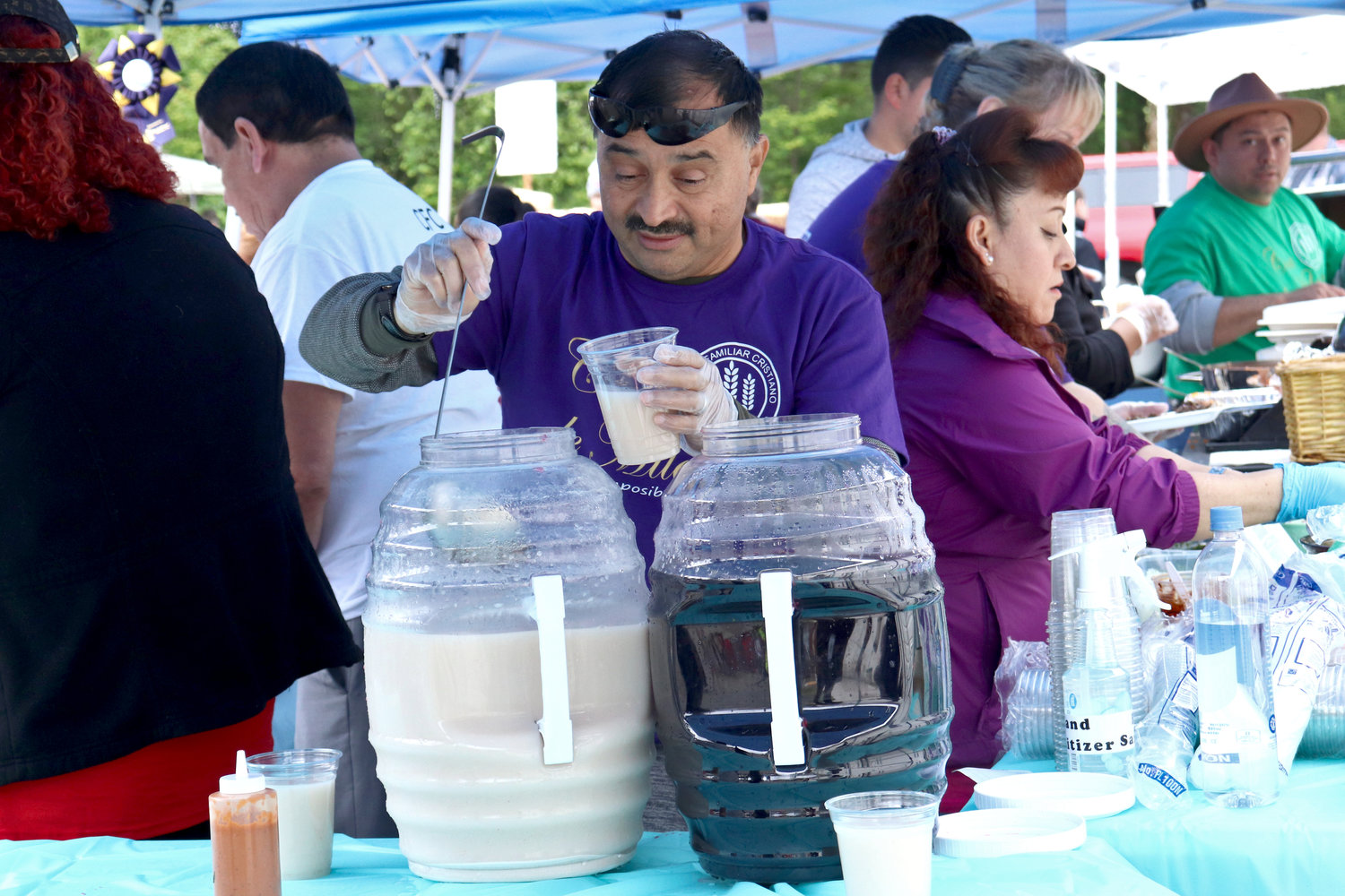 A volunteer with Iglesia Centro Familiar Cristiano serves horchata during the Swede Day celebration in Rochester on Saturday.