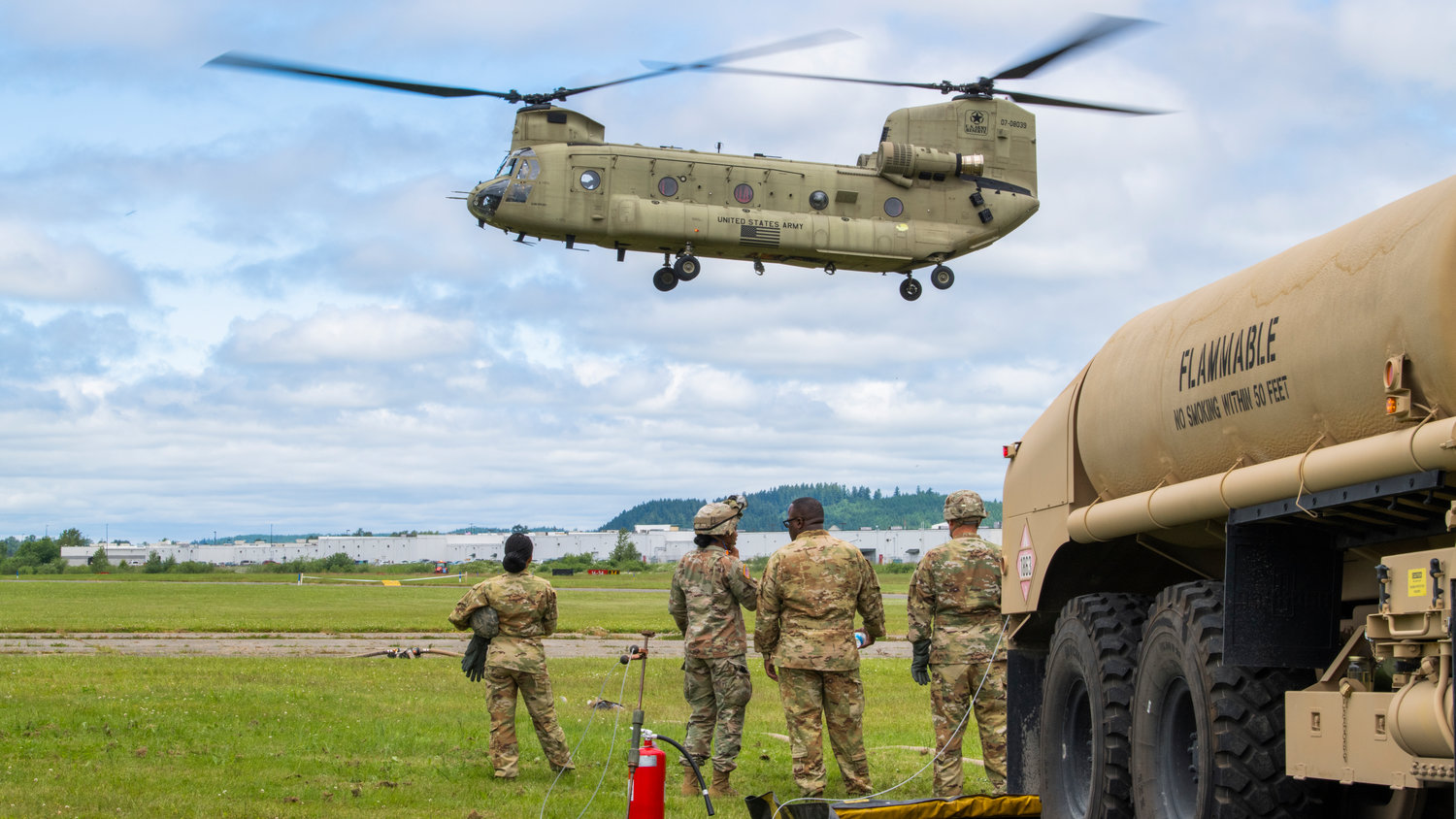 Members of the United States Army from Joint Base Lewis-McChord watch as a Chinook helicopter prepares to land at the Chehalis-Centralia Airport during a military training exercise on Wednesday. Look for a full story and additional photographs from the training in Saturday’s edition of The Chronicle.