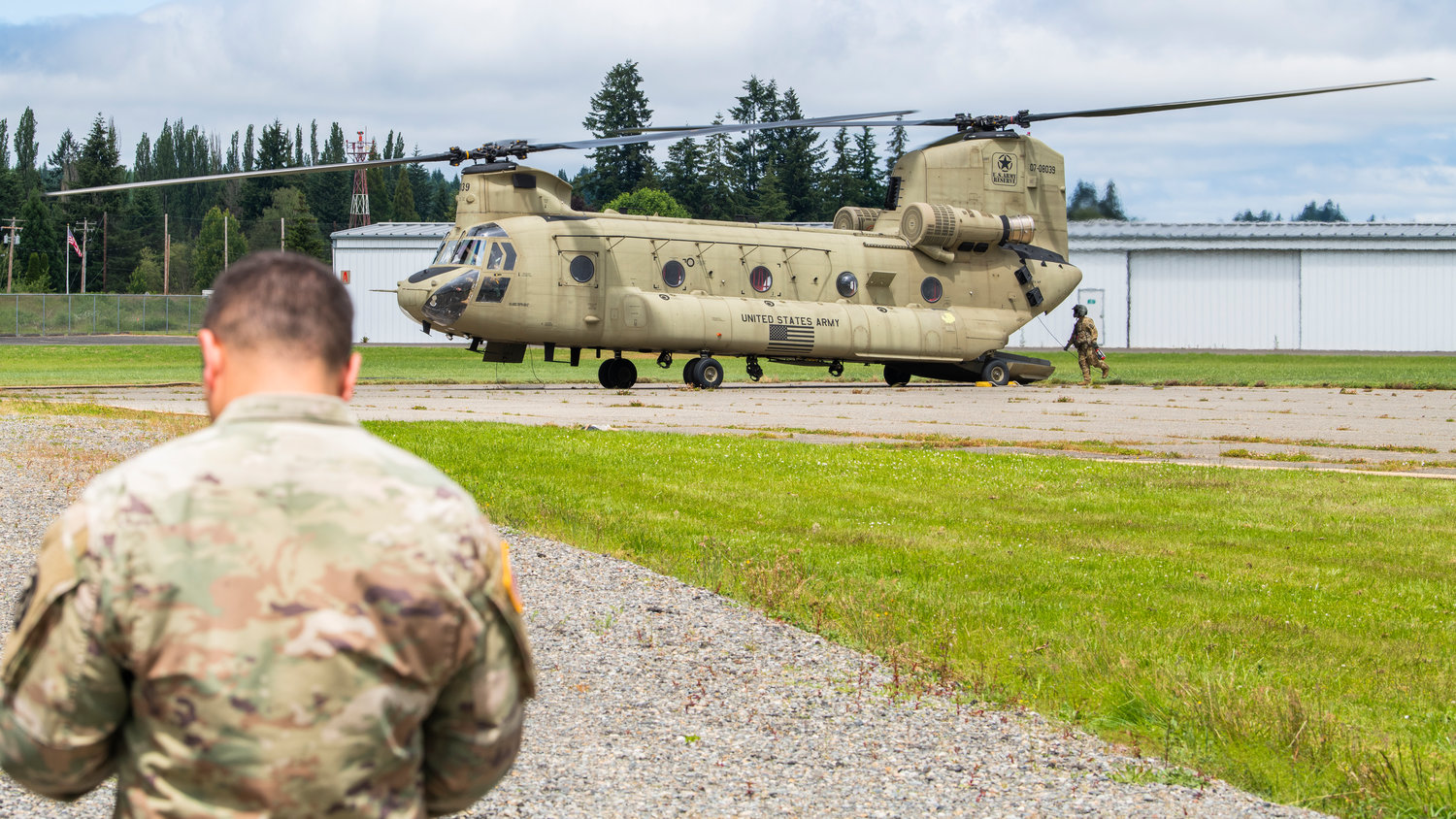 Crews from Joint Base Lewis-McChord exit a Chinook helicopter after a landing at the Chehalis-Centralia Airport as they prepare to fuel up during a military training exercise on Wednesday.