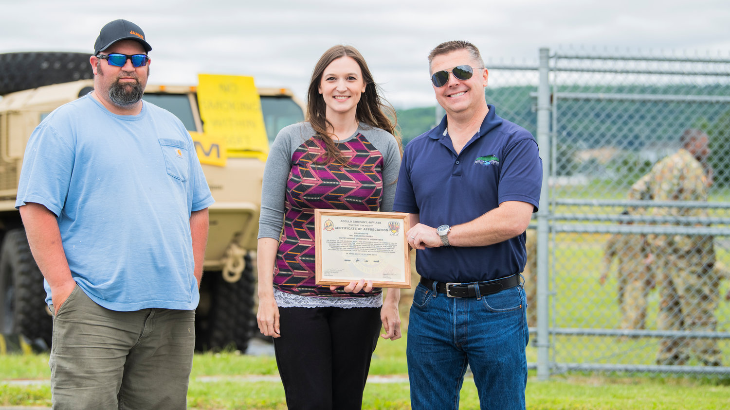 From left, Austin Barnes, Tara Sawyer, and Brandon Rakes pose for a photo with a certificate of appreciation from Apollo Company at the Chehalis-Centralia Airport during a military training exercise on Wednesday.