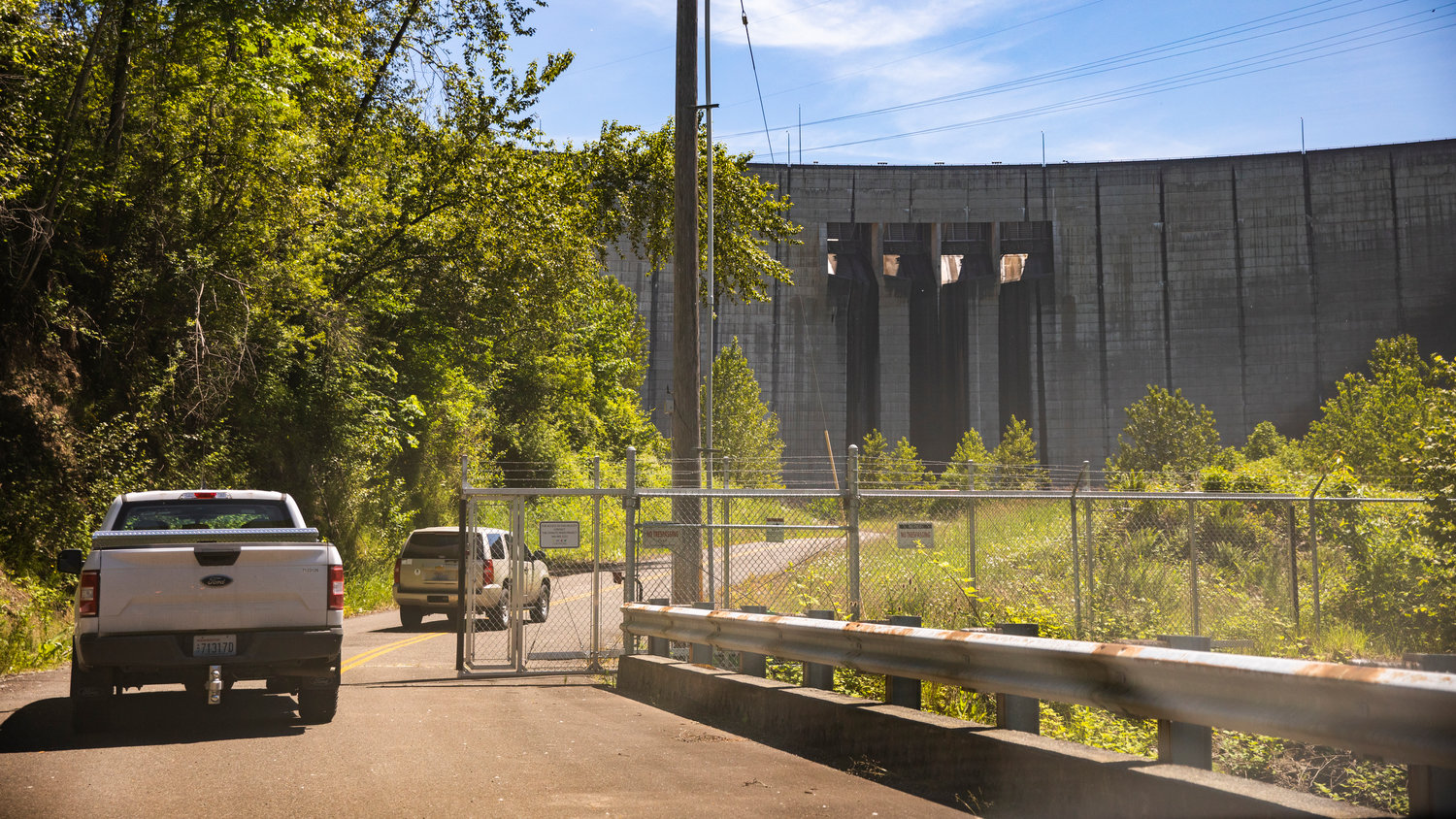 Vehicles enter the Tacoma City Light powerhouse gates near the Mossyrock Dam.