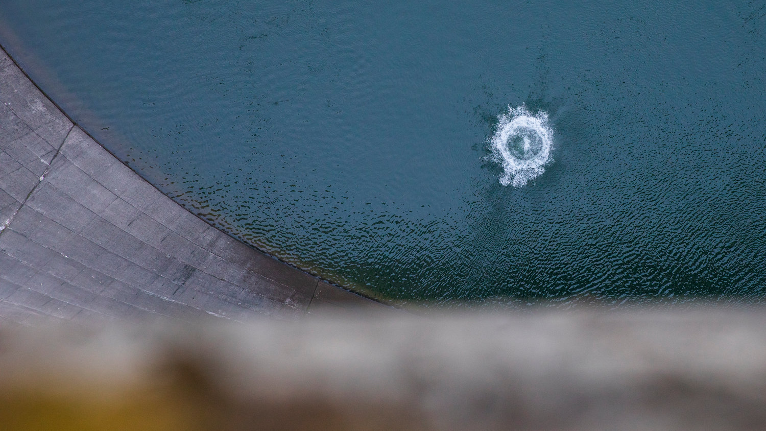 A rock makes a loud splash after being dropped from the top of the Mossyrock Dam Tuesday morning. The dam is the tallest in the state and from bedrock to top is taller than the space needle.