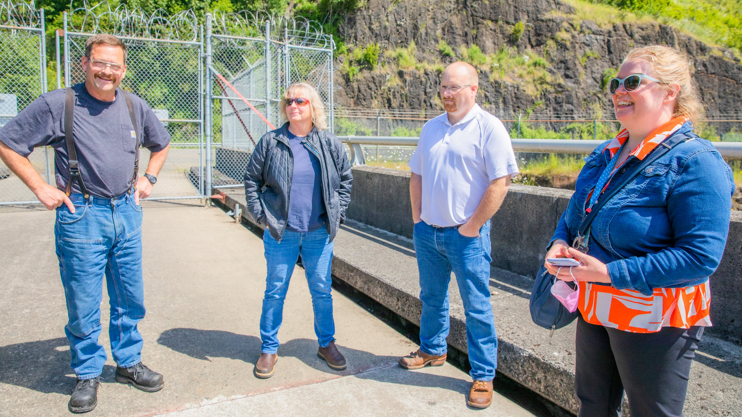 From left, Clarence Lupo, Kyrra Wilson, Chad Chalmers, and Monika Sundbaum stand on the Mossyrock Dam Tuesday morning.