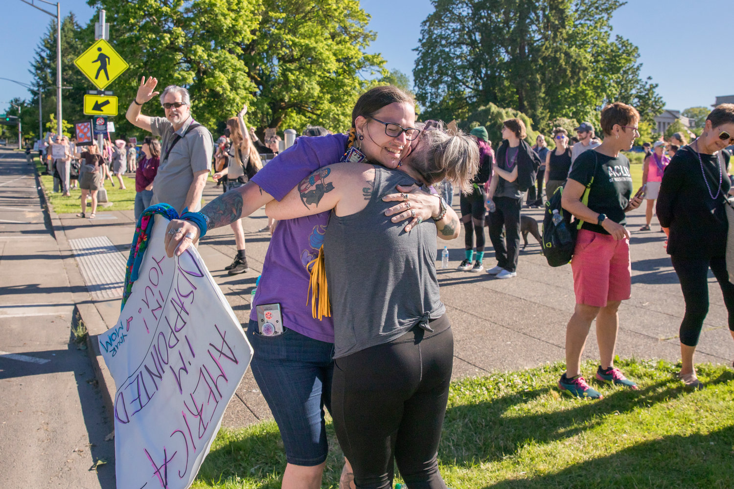 Attendees embrace at a rally in support of abortion rights Friday afternoon in Olympia.