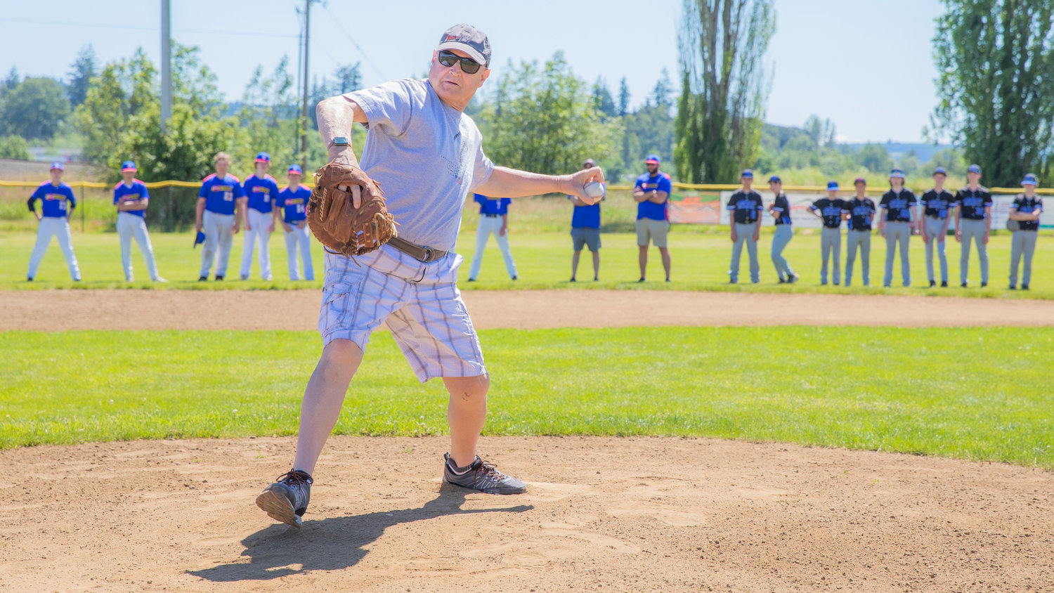 Tim Gilmore throws out the first pitch during closing ceremonies at Stan Hedwall Park in Chehalis on Saturday.