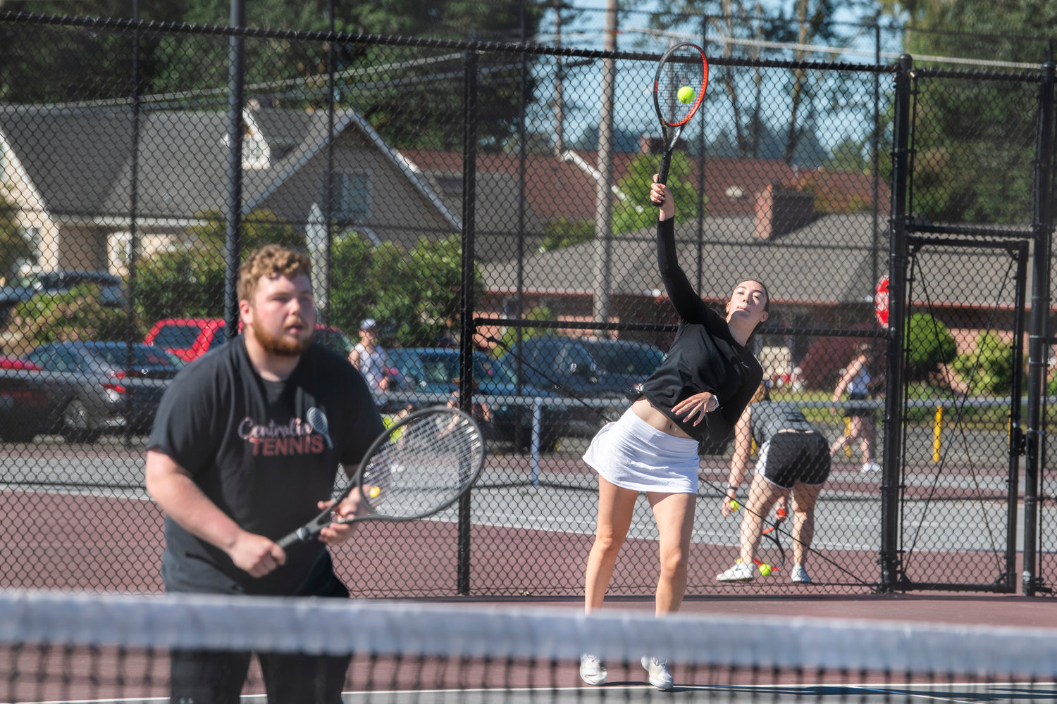 Claire Kuykendall, a Bearcat, serves during a doubles match with Ryan Mack, a Centralia graduate, during the Jack State Tennis Tournament at W.F. West High School on Saturday.